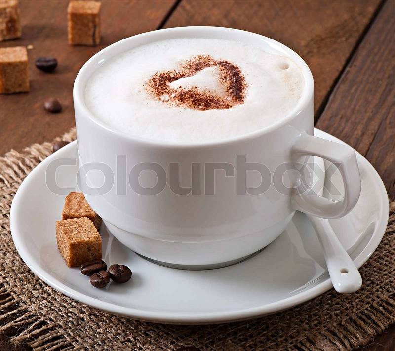 Cup of latte on the old wooden background, stock photo