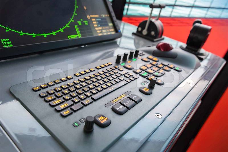 Modern ship control panel with radar screen, accelerator, trackball and keyboard, stock photo