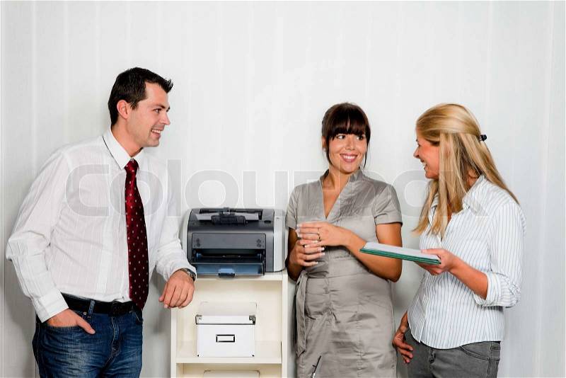 Conversation among several employees in an office, stock photo