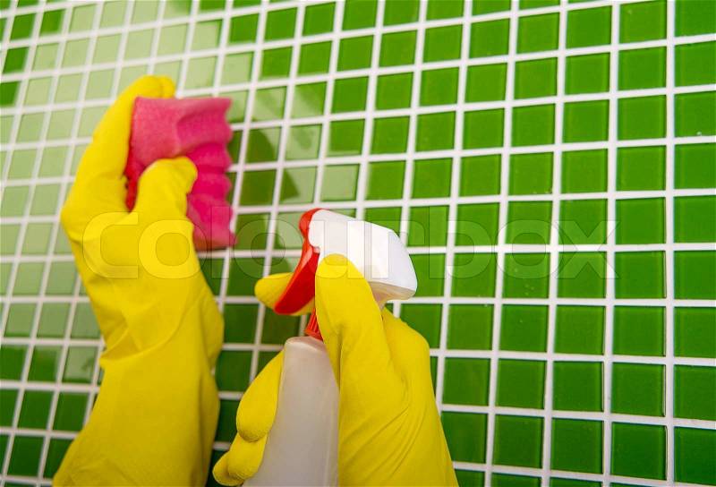 Washing the tiles in the bathroom, cleaning kit apartment, hygienic cleaning, gloves, sponge and powder, stock photo