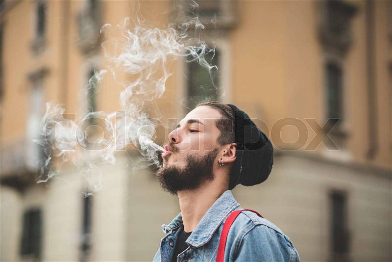 12098626-young-handsome-bearded-hipster-man-smoking-cigarette.jpg