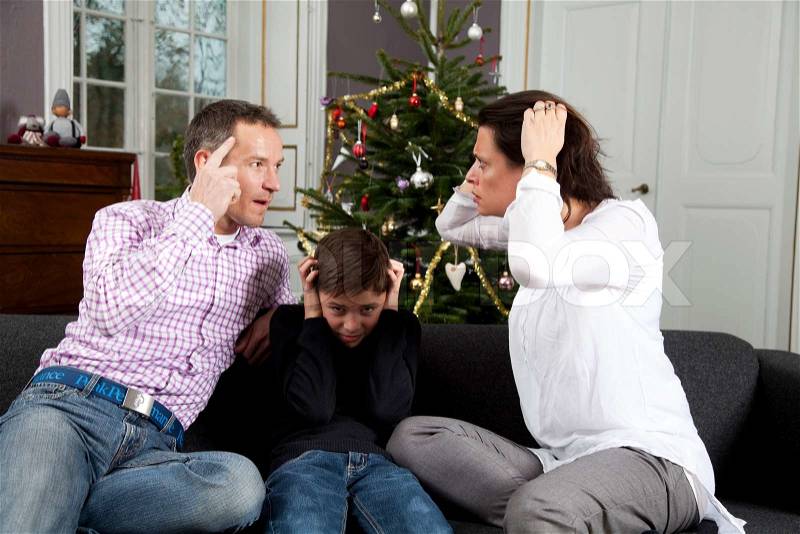 Unhappy son of a divorced parents on Christmas day, stock photo