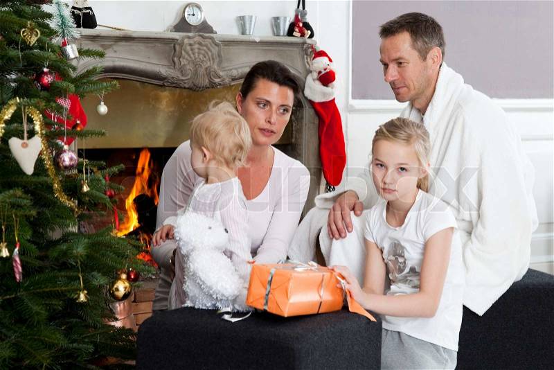 A caucasian family celebrating Christmas morning under the Christmas tree, stock photo