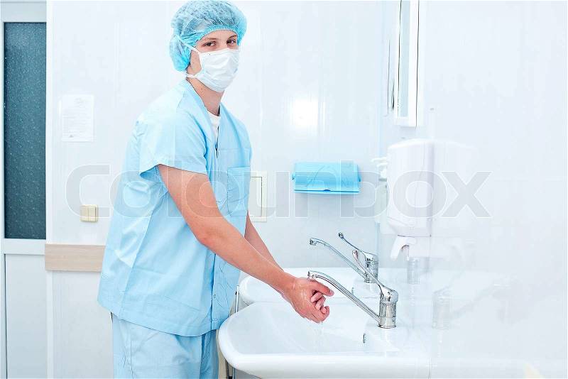 Male surgeon washes his hands before the operation, stock photo