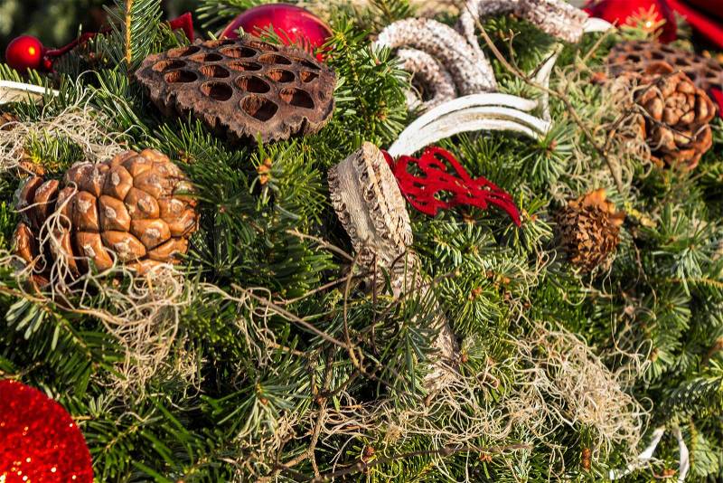 Christmas background with toys, cake and fir-cones on fir tree branches with shallow depth of field, stock photo