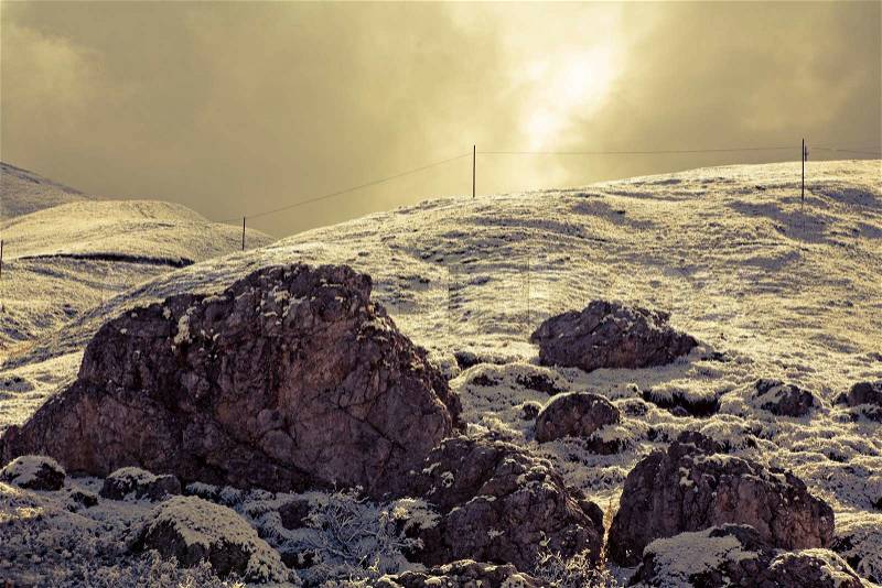 September morning after a light snow storm in the Dolomites. Image is cross processed and a little film grain added to reflect age, stock photo