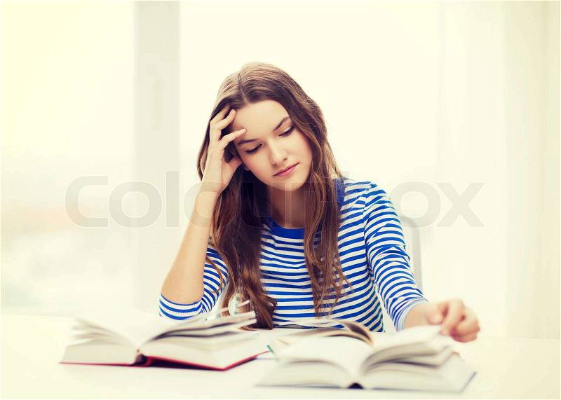 Education and home concept - stressed student girl with books, stock photo