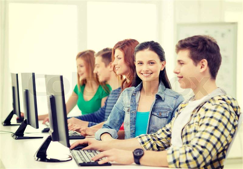 Education, technology and internet - smiling female student with computer studying at school, stock photo