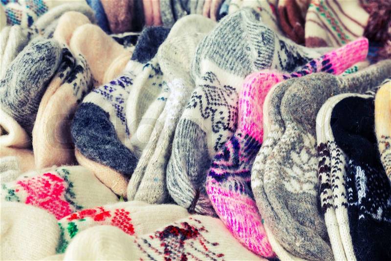 Many knitted woolen socks on the counter. Vintage toned photo with filter effect, stock photo