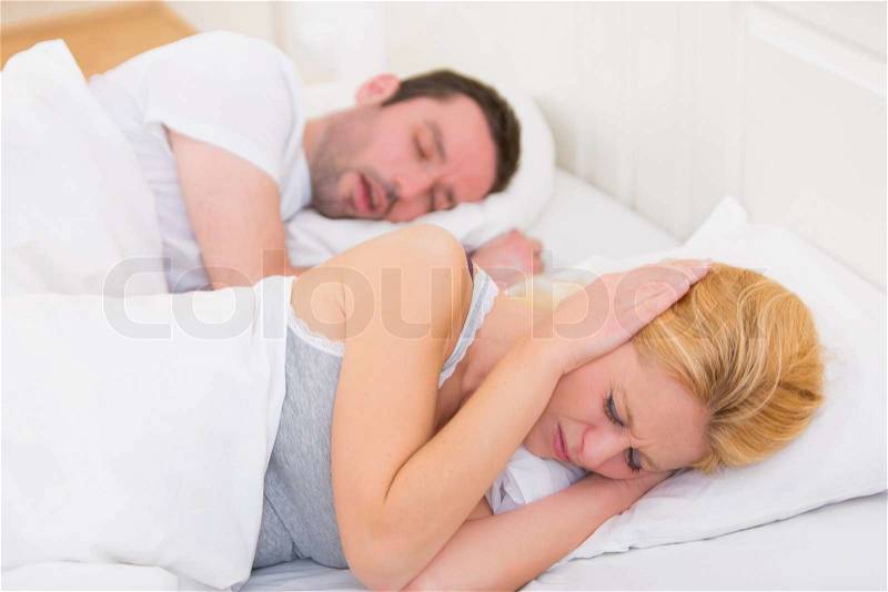 View of a Young woman can\'t sleep because of boyfriend\'s snoring, stock photo