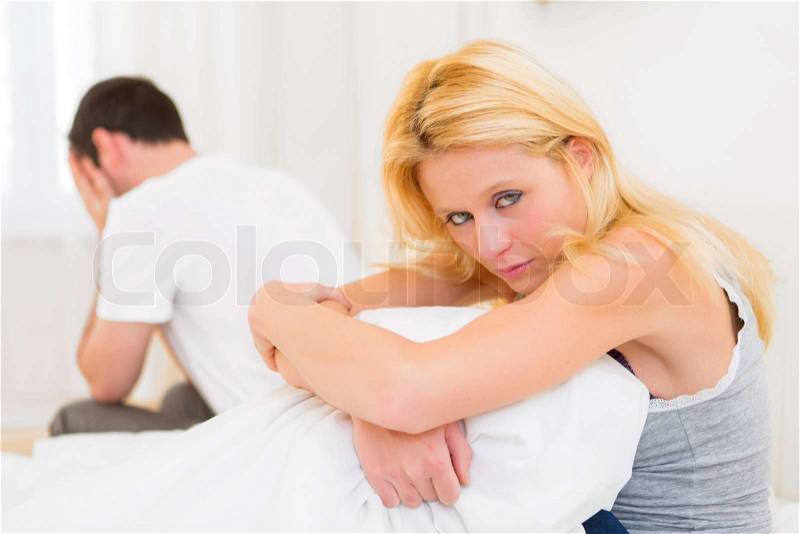 View of a Young attractive couple having an argue in bed, stock photo