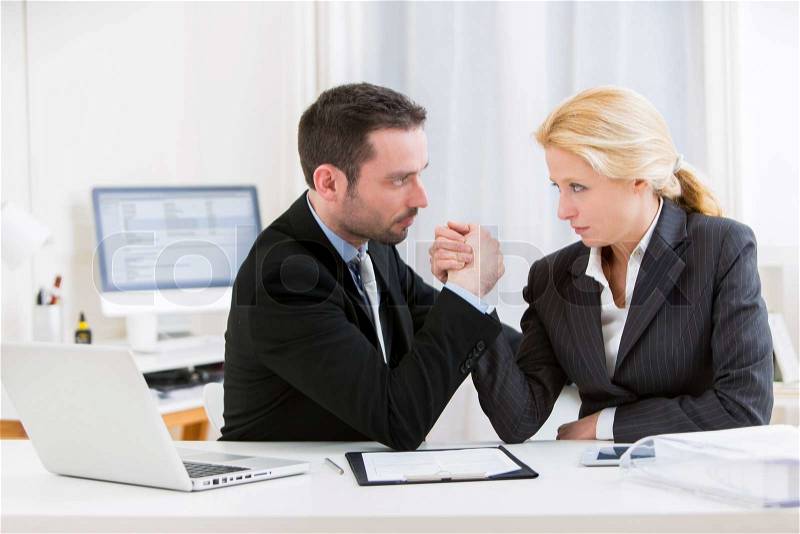 View of a Business man arm wrestling at the office, stock photo