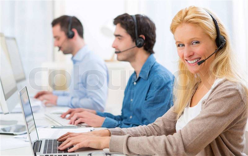 View of a Young attractive woman working in a call center, stock photo