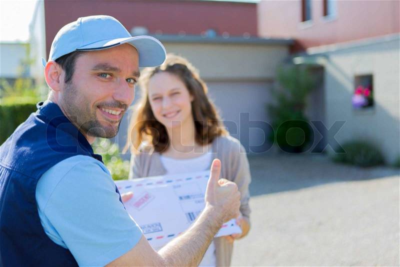 View of a Delivery man handing over a registered mail, stock photo