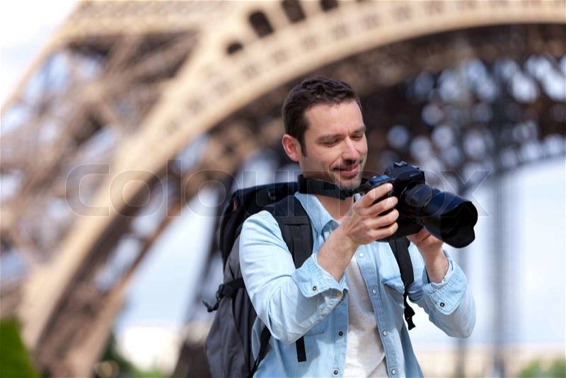 View of a Young attractive tourist taking pictures in Paris, France, stock photo