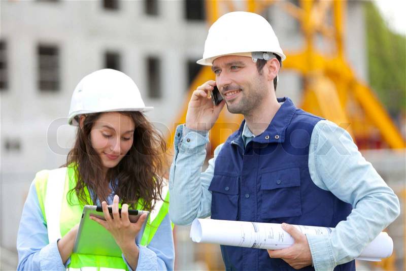 Portrait of co-workers on a construction site, stock photo