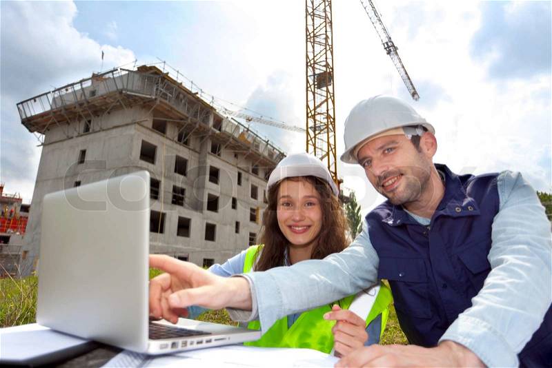 View of Co-workers working on a construction site, stock photo