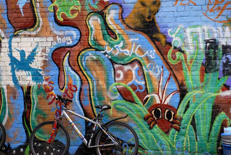 MTB bicycle and urban graffiti art on the side of a building, stock photo