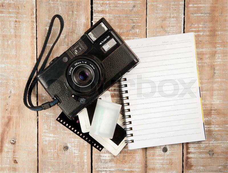 Old camera and film with diary on a wooden, stock photo