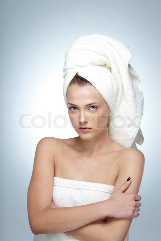 Portrait of cute young woman with fresh skin and towel on head, stock photo