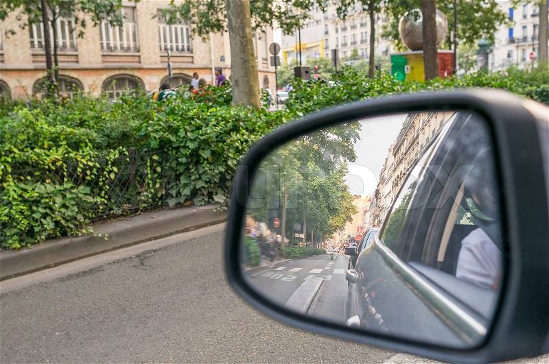 Driving in a big city. Rear mirror view, stock photo