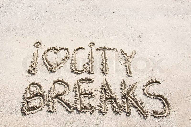 I Love City Breaks message written on sand, vacation concept, stock photo
