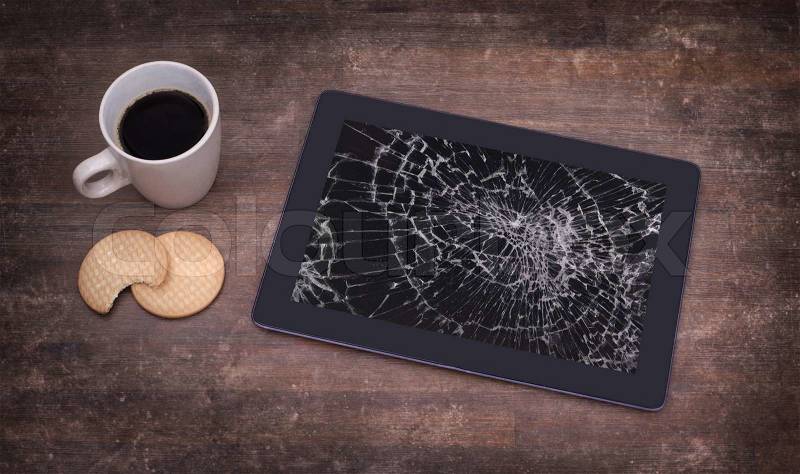 Tablet computer with broken glass, screen destroyed, stock photo