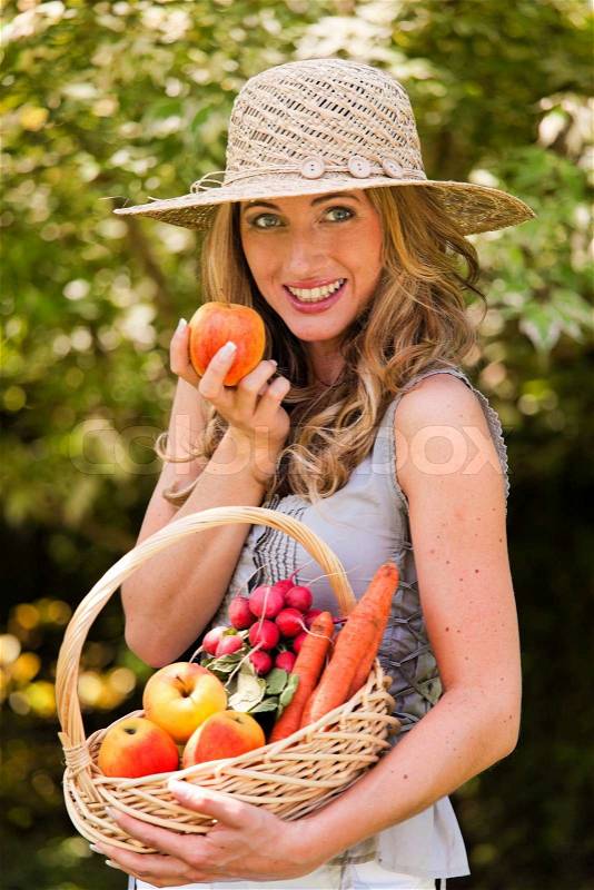 Woman with basket of fruit from the garden, stock photo