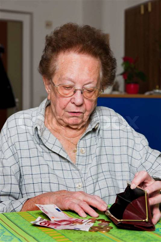 Old woman counts her money, stock photo