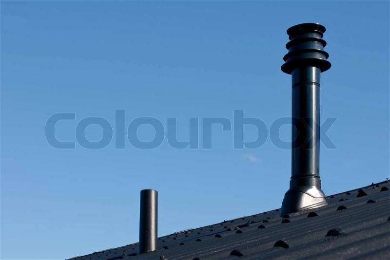 Roof with ventilation pipe and flue terminal from natural gas boiler, stock photo