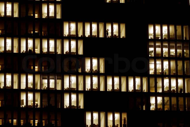 The lighted windows of an office building. Power and energy, stock photo