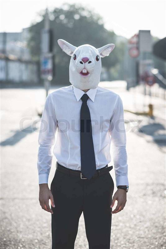 Rabbit mask young handsome elegant blonde model man in the city, stock photo