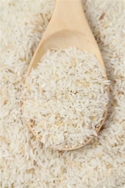 Close up raw rice and wood spoon, stock photo