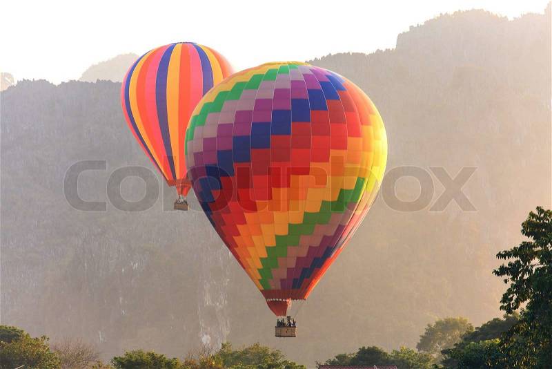 Hot air balloon over mountain, Vang Vieng, Laos, stock photo