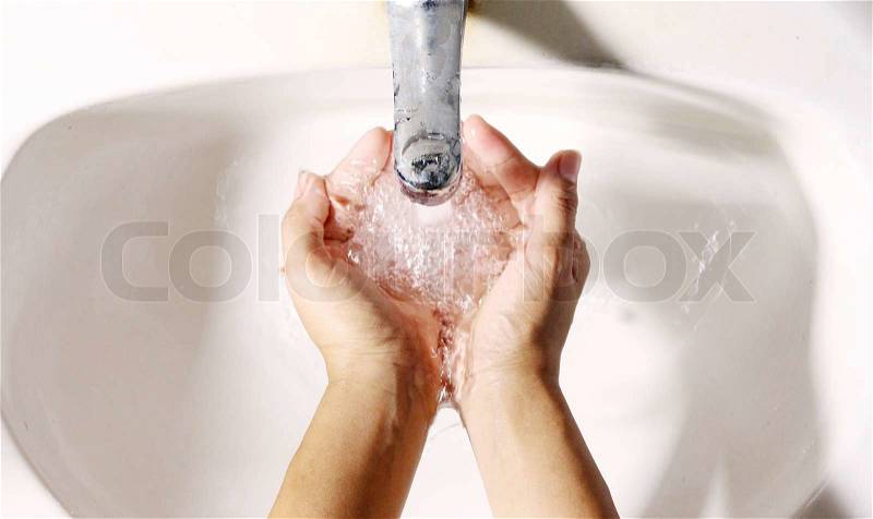 Woman washing, cleaning hand by water from trap in sink lavatory, stock photo