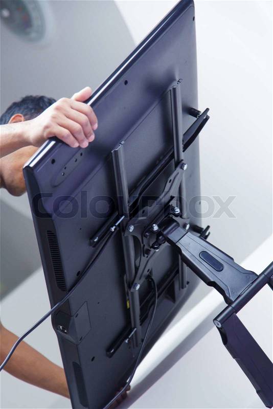 Installing mount TV on the wall at home or office, stock photo