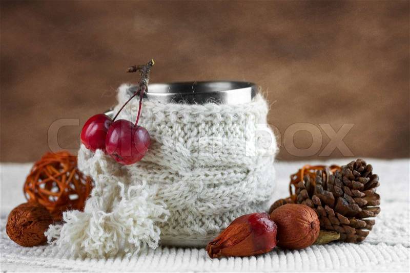Cup in knitted cover with paradise apples , stock photo