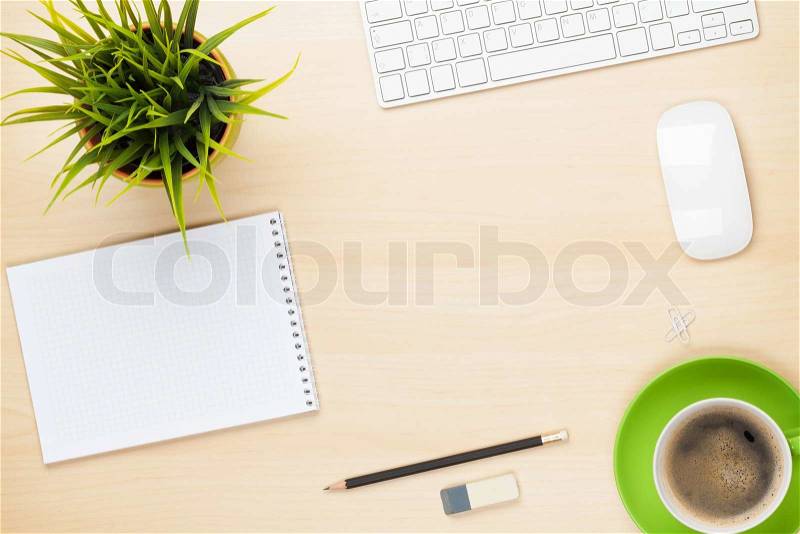 Office table with notepad, computer, coffee cup and flower. View from above with copy space, stock photo