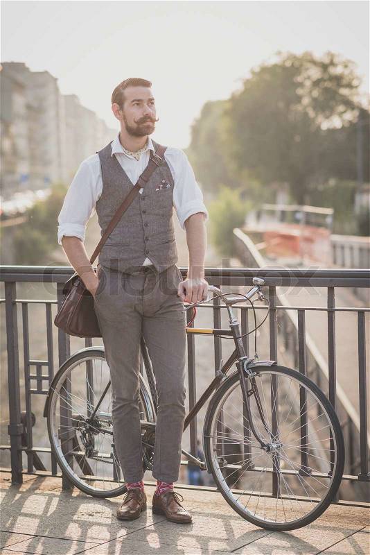 Handsome big moustache hipster man with bicycle in the city, stock photo
