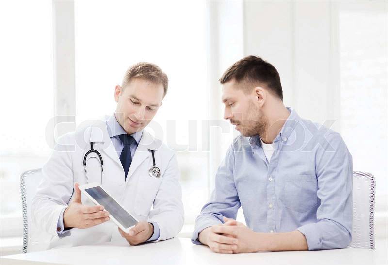 Healthcare, technology and medicine concept - serious doctor with tablet pc computer and patient in hospital, stock photo