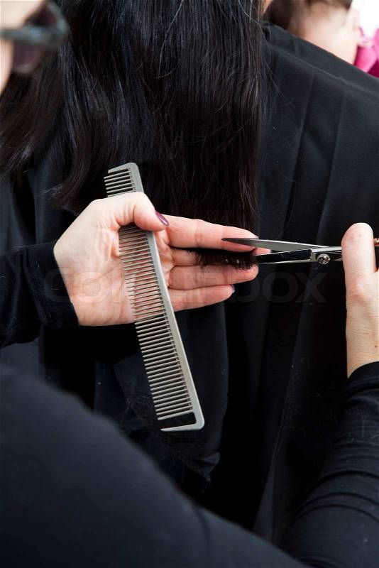 A woman getting a hair cut, stock photo