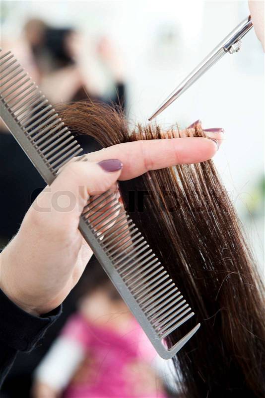 A woman getting a hair cut, stock photo