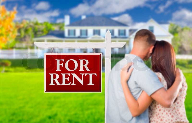 For Rent Real Estate Sign and Affectionate Military Couple Looking at Nice New House, stock photo