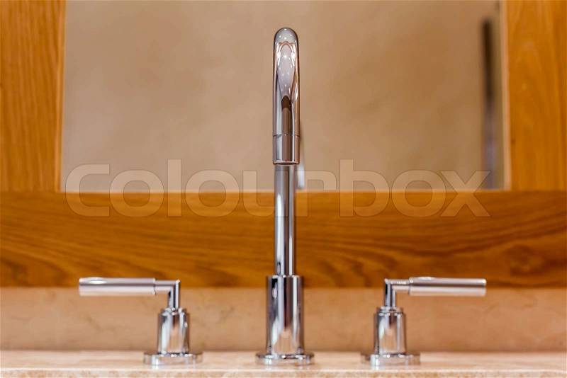 Front view of Faucet and marble sink in the luxury hotel, stock photo
