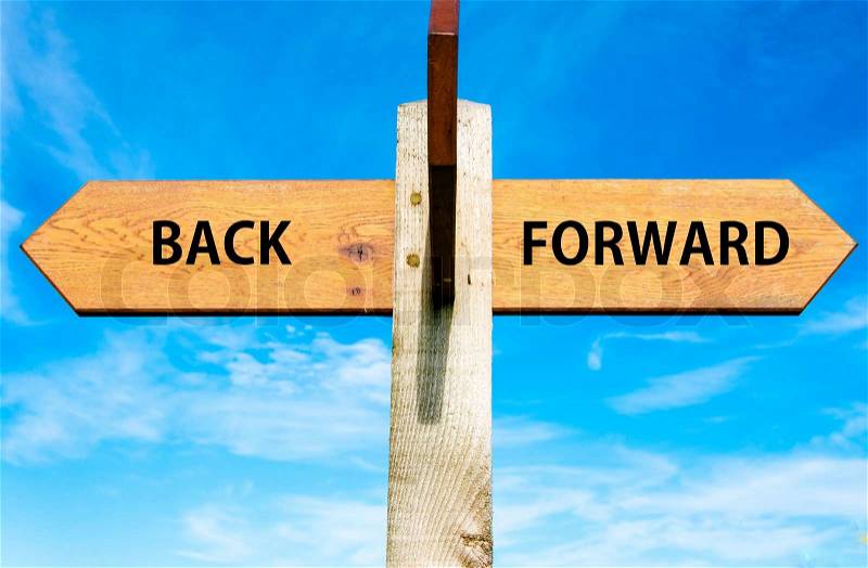 Blank wooden signpost with two arrows over clear blue sky with copy space, stock photo