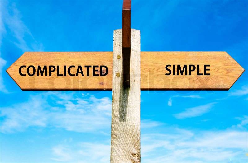 Blank wooden signpost with two arrows over clear blue sky with copy space, stock photo