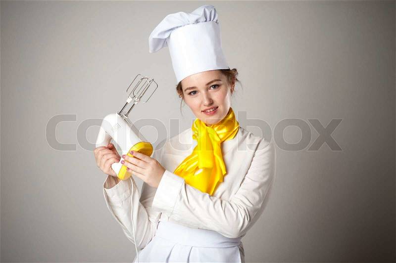 Photo of a smiling cook with mixer, stock photo