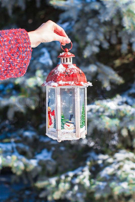 Closeup of hand holding beautiful vintage Christmas lantern, stock photo