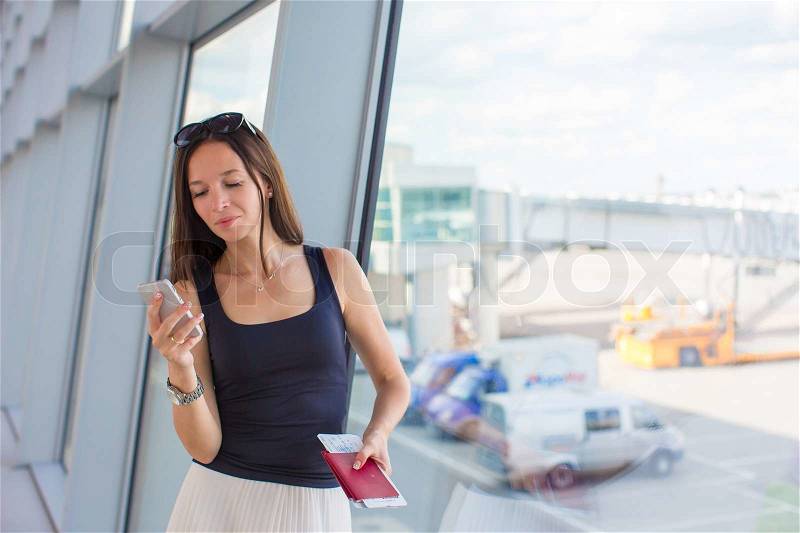 Close up of woman holding passports and boarding passport at airport, stock photo