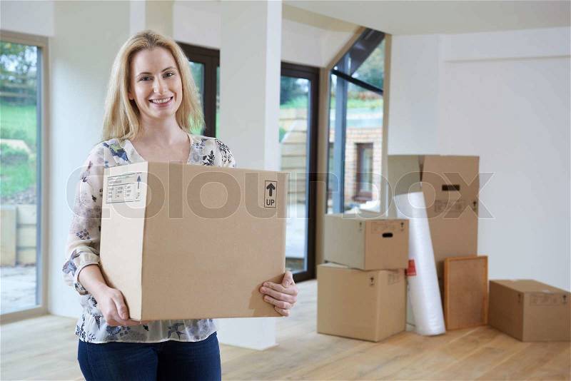 Woman Moving Into New Home With Packing Box, stock photo